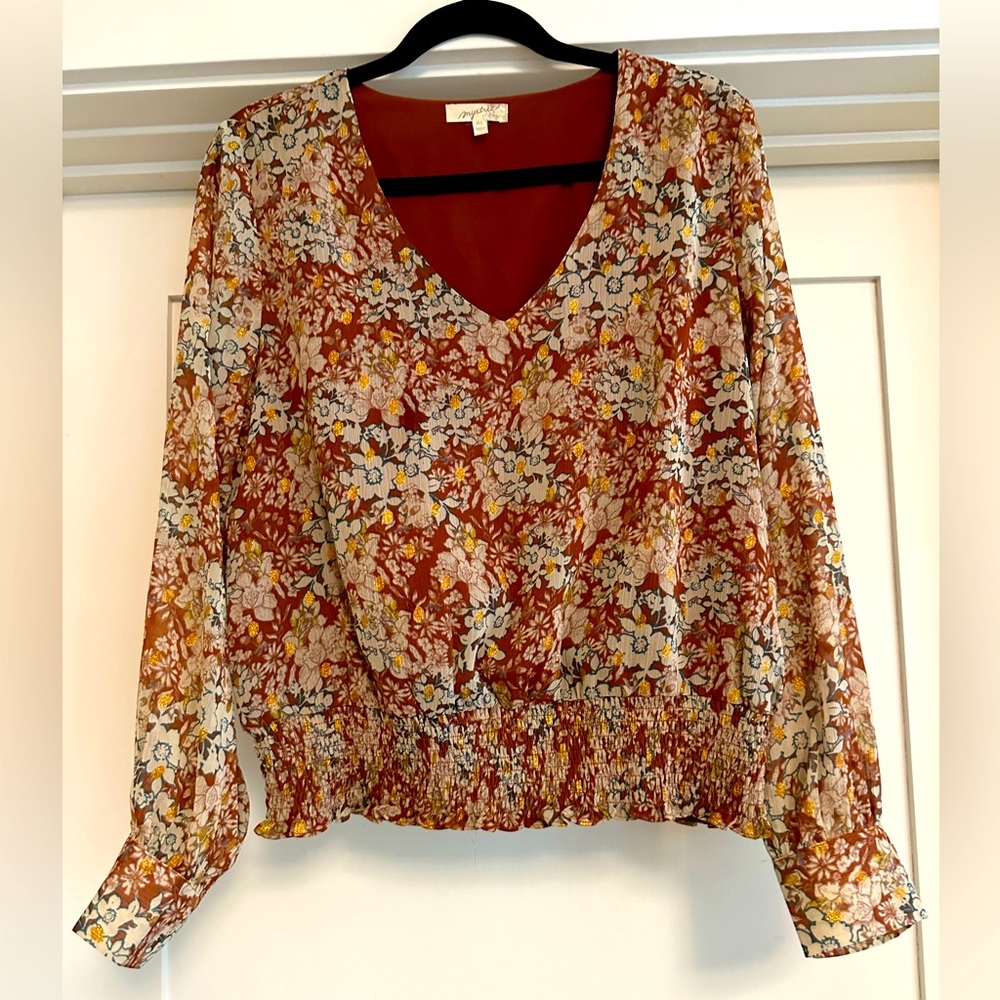 Beautiful cinched blouse with gold lamee accents.
